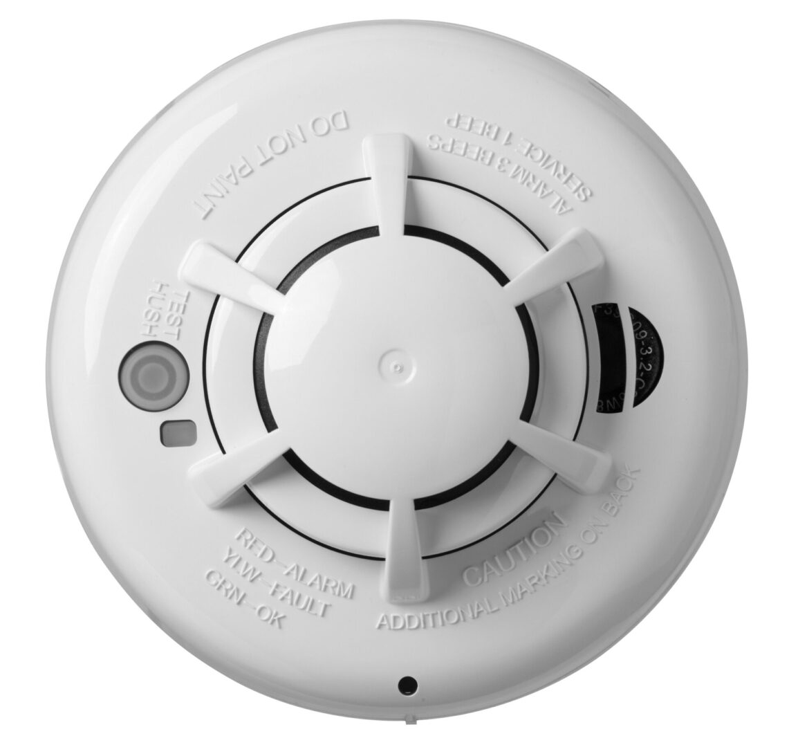 A smoke detector is shown with the front of it.
